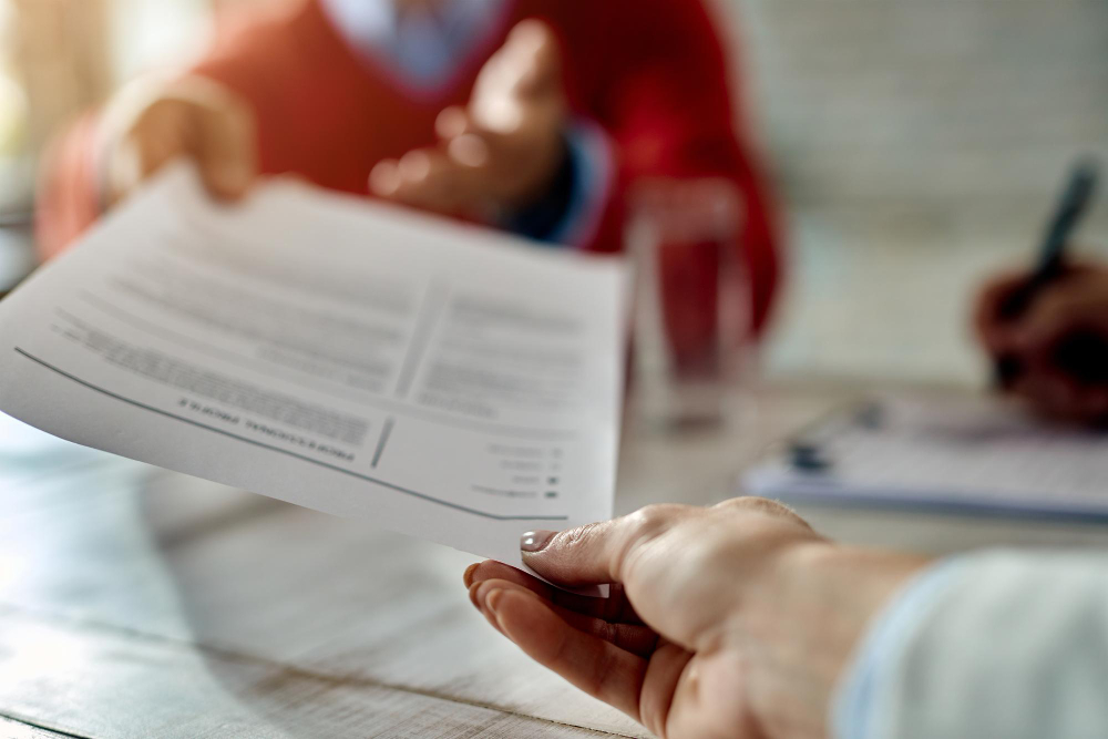une personne tendant son CV à une autre
